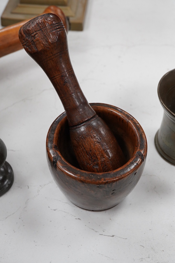 Sundry items to include a large pestle, spice grinder, flat iron on stand, bronze mortar and three other items, largest 42cm in length